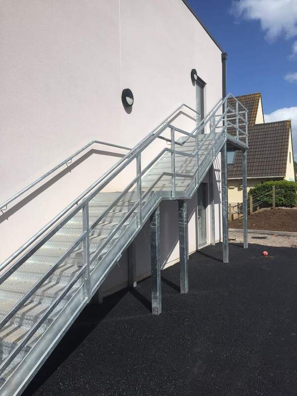 Metal fire escape staircase with tube steel handrail