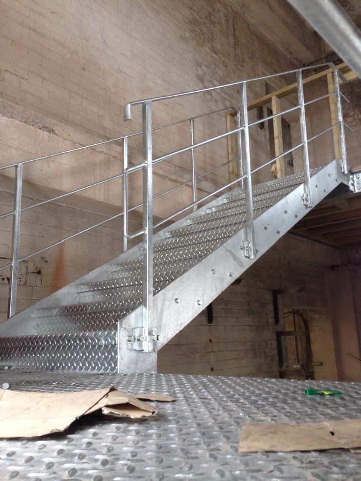 Galvanized steel staircase with simple metal handrail 