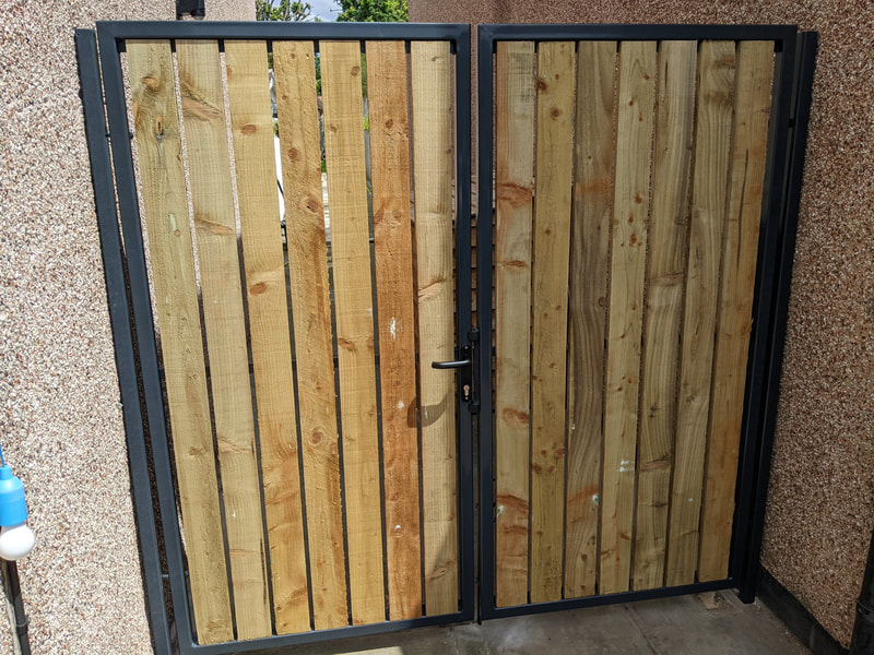 Metal driveway gate in Bristol with timber panel in-fill