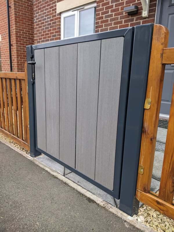Powder coated metal gate with a composite deck in-fill